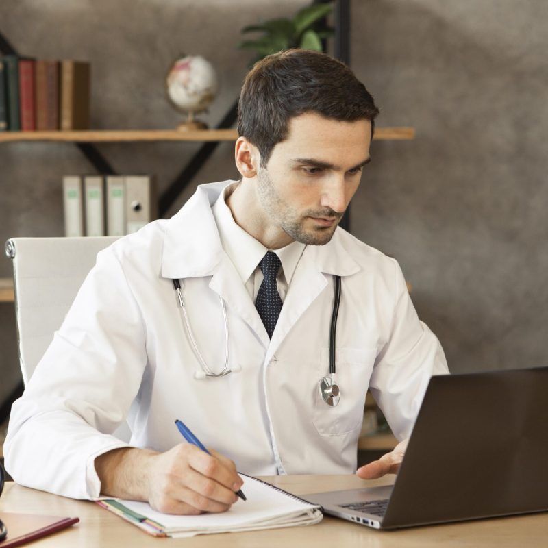 medium-shot-doctor-working-laptop